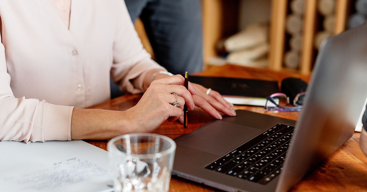 A small business owner filling in a one-page blog content brief on a laptop.